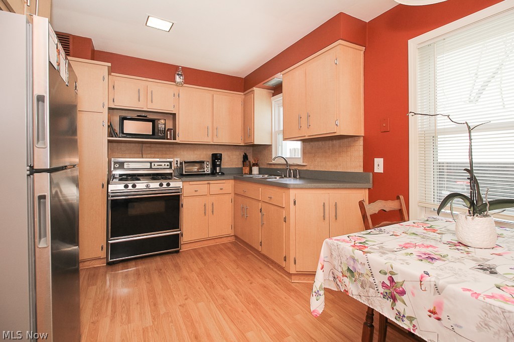 1328 Belrose Road Cleveland, OH 44124 - Photo 5 of 19 The kitchen has black & stainless steel appliances.