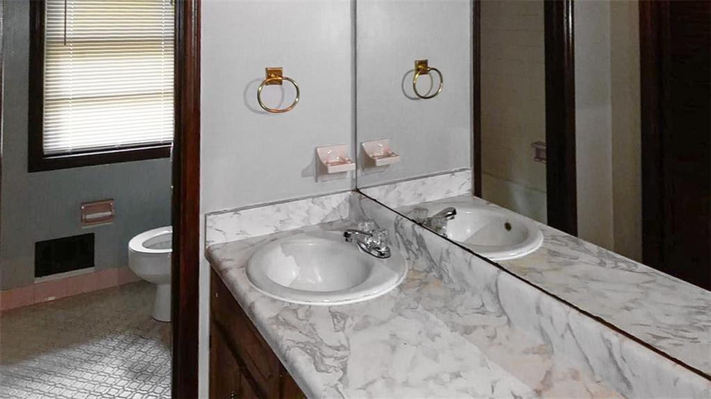 5844 Old Bill Cook Road Atlanta, GA 30349 - Photo 3 of 32 a bathroom with a granite countertop sink a mirror and bathtub