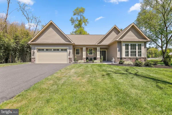 a kitchen with stainless steel appliances granite countertop a kitchen island a stove and a sink