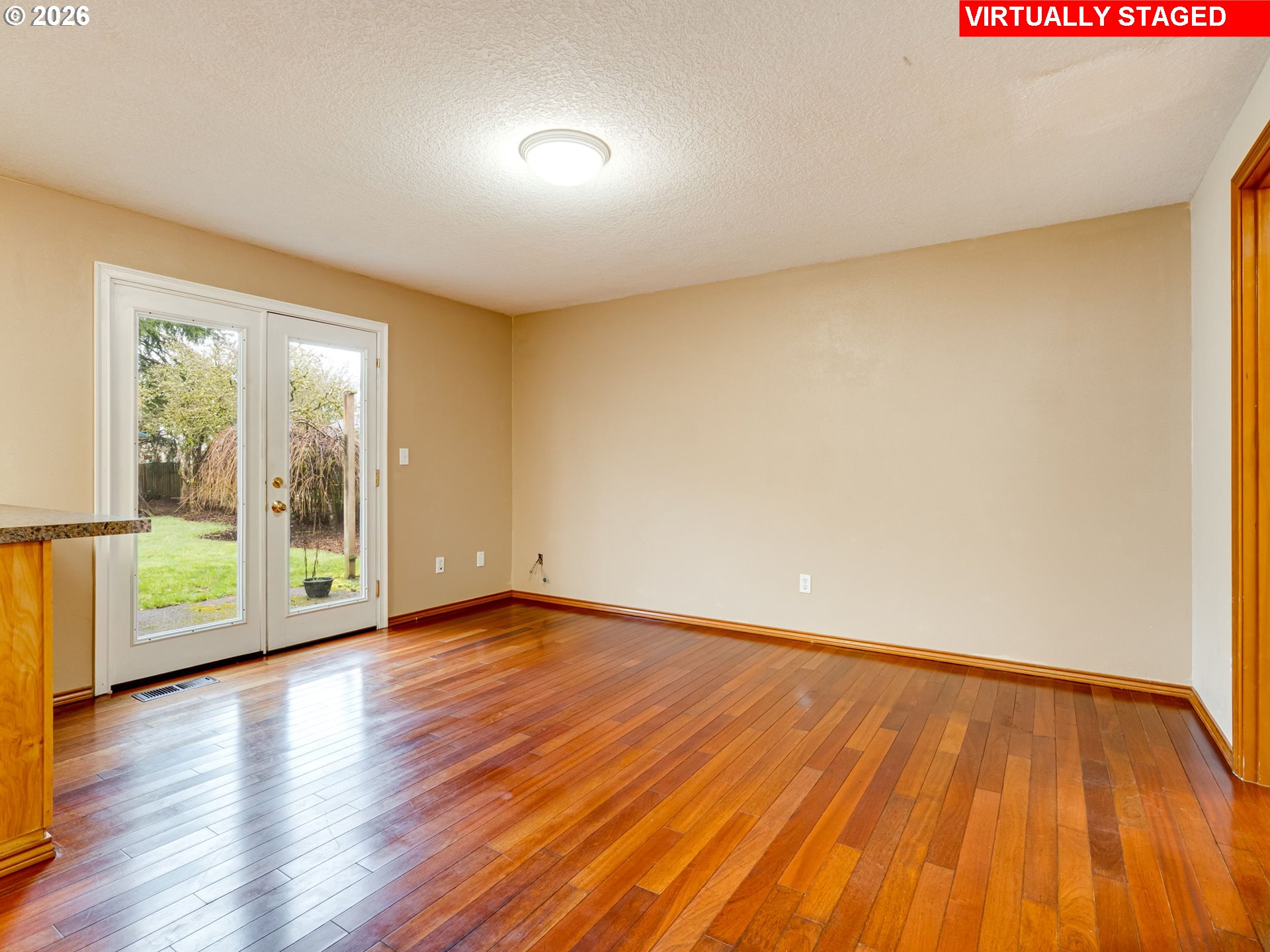 1250 South Cedar Loop Canby, OR 97013 - Photo 14 of 42 a view of an empty room with wooden floor and a window