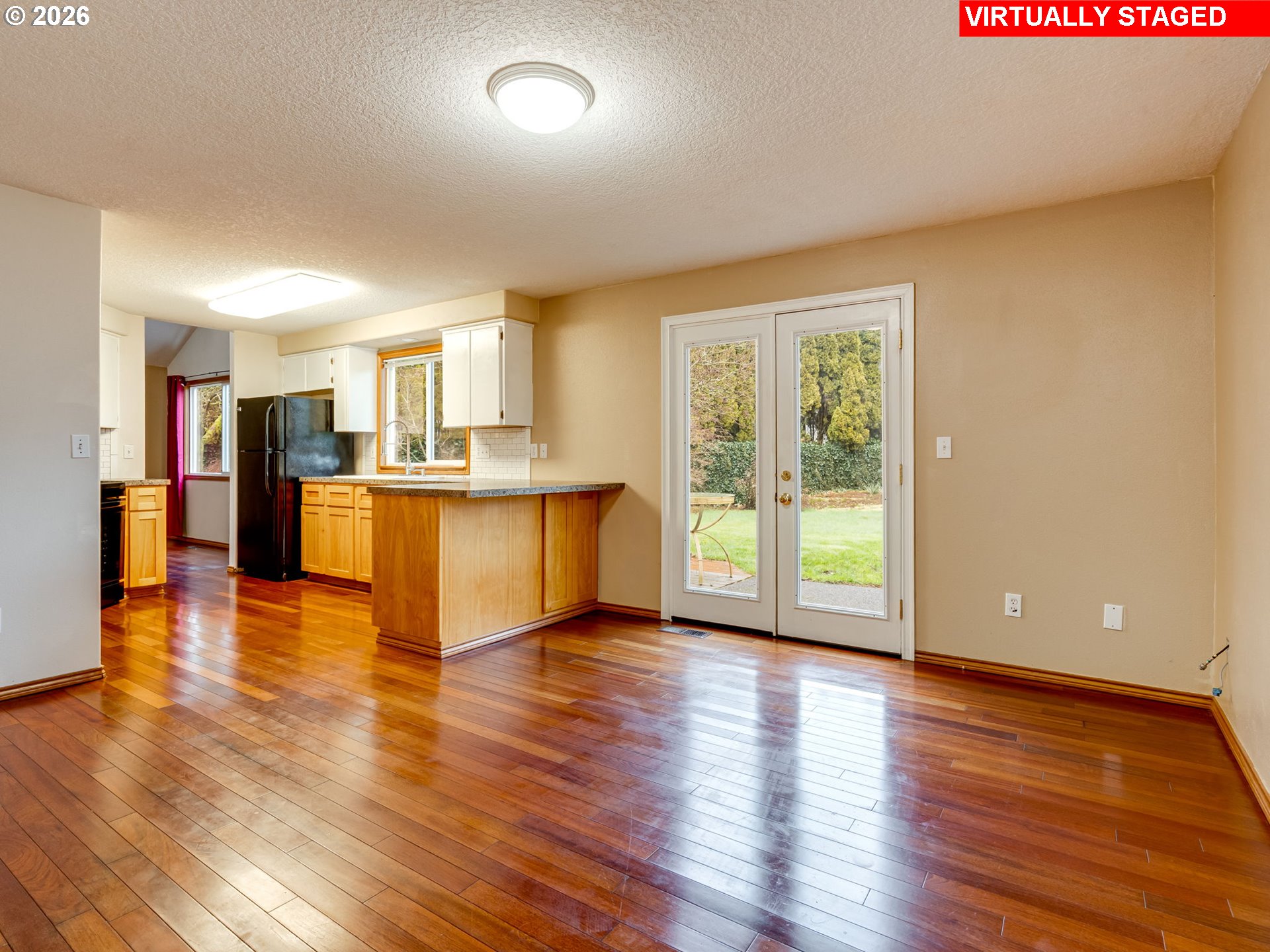 1250 South Cedar Loop Canby, OR 97013 - Photo 15 of 42 a view of a kitchen with a stove wooden cabinets and a large window