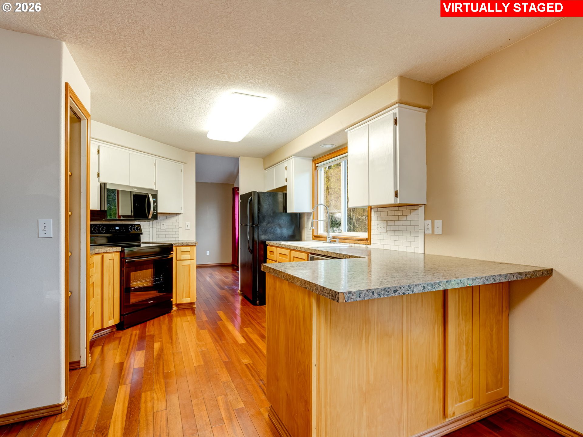 1250 South Cedar Loop Canby, OR 97013 - Photo 17 of 42 a kitchen with stainless steel appliances granite countertop a sink a stove top oven a counter space and cabinets