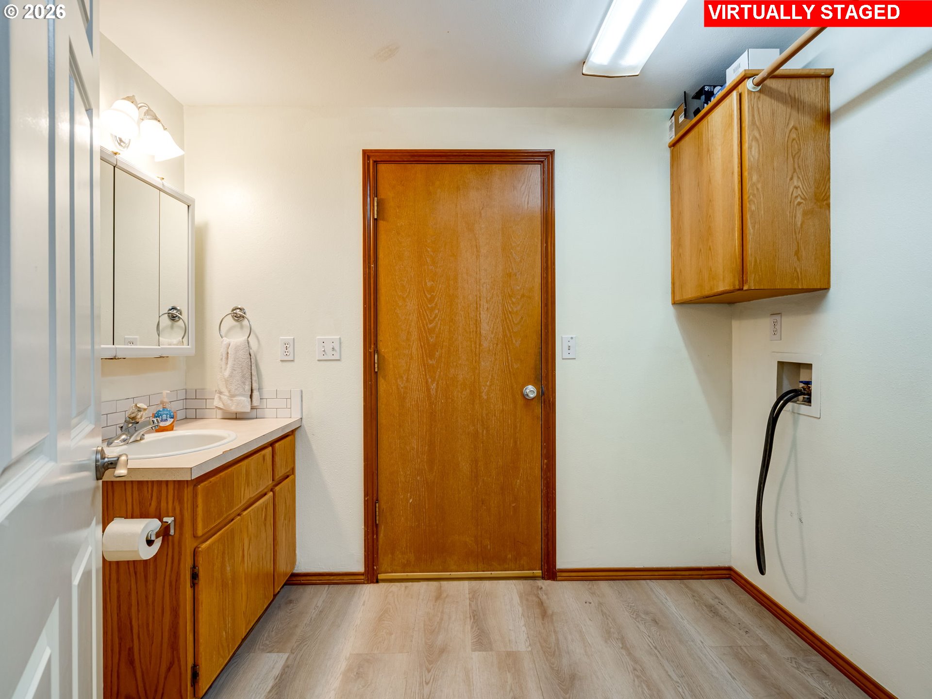 1250 South Cedar Loop Canby, OR 97013 - Photo 22 of 42 a view of a bathroom with a sink mirror and bathtub