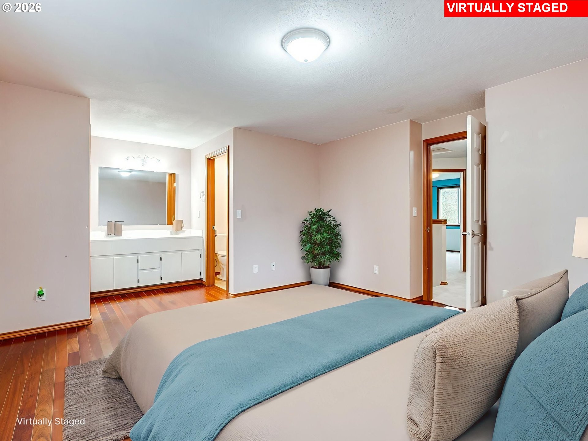 1250 South Cedar Loop Canby, OR 97013 - Photo 26 of 42 a bedroom with a large bed and potted plant