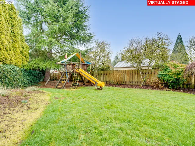 a view of a house with a yard and sitting area