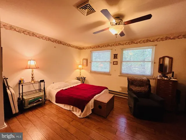a bedroom with furniture and a window