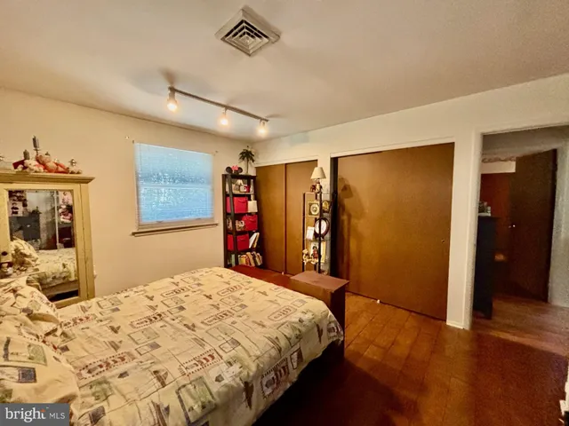 a bed room with a bed and a large mirror