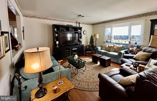 a living room with furniture and a flat screen tv