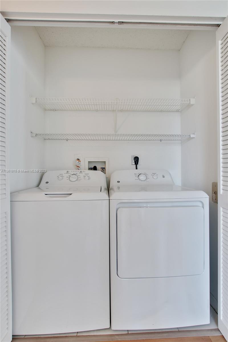1111 Brickell Bay Drive, Unit 1102 Miami, FL 33131 - Photo 19 of 72 a utility room with dryer and washer