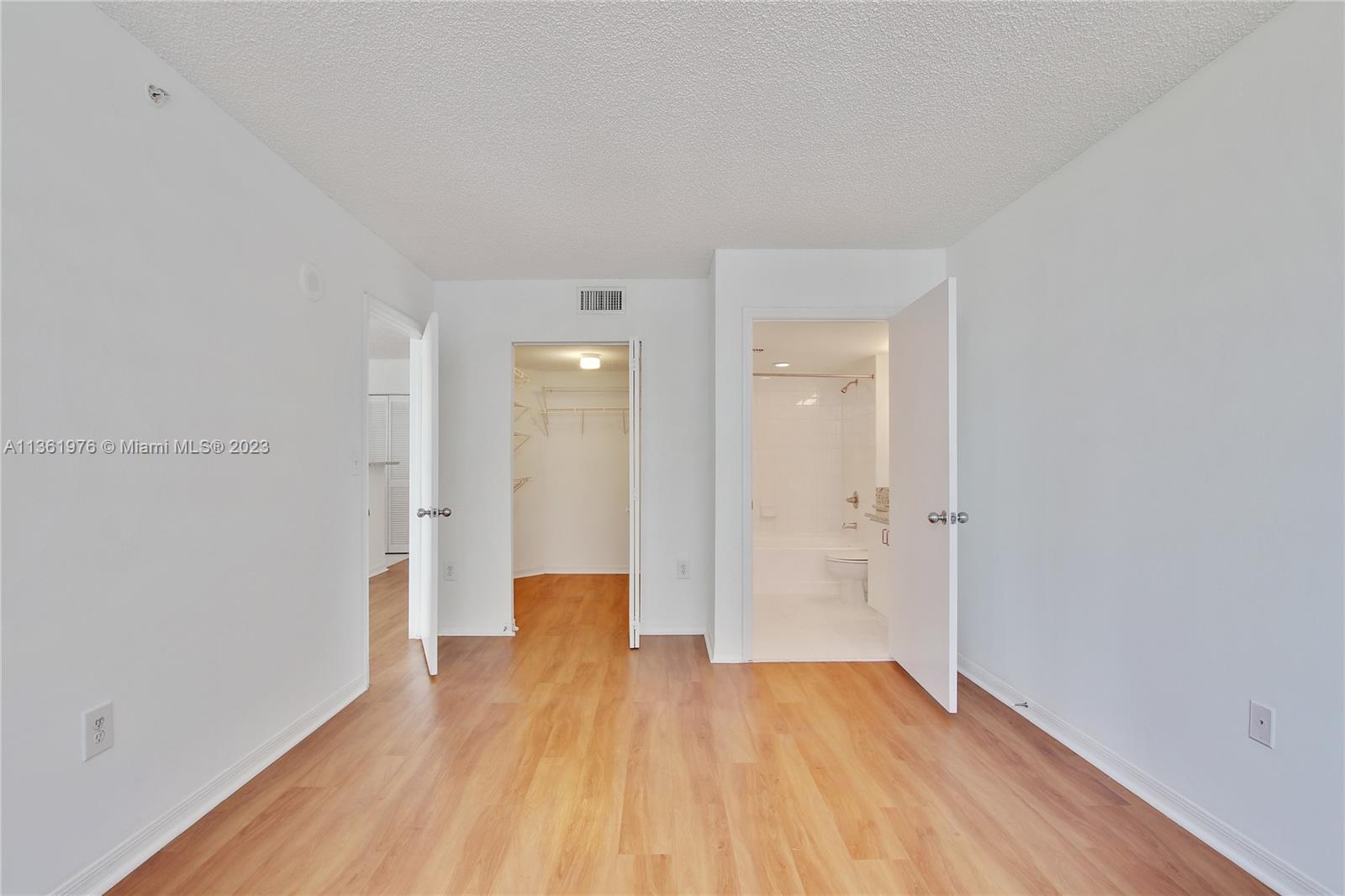 1111 Brickell Bay Drive, Unit 1102 Miami, FL 33131 - Photo 21 of 72 a view of a room with wooden floor and windows