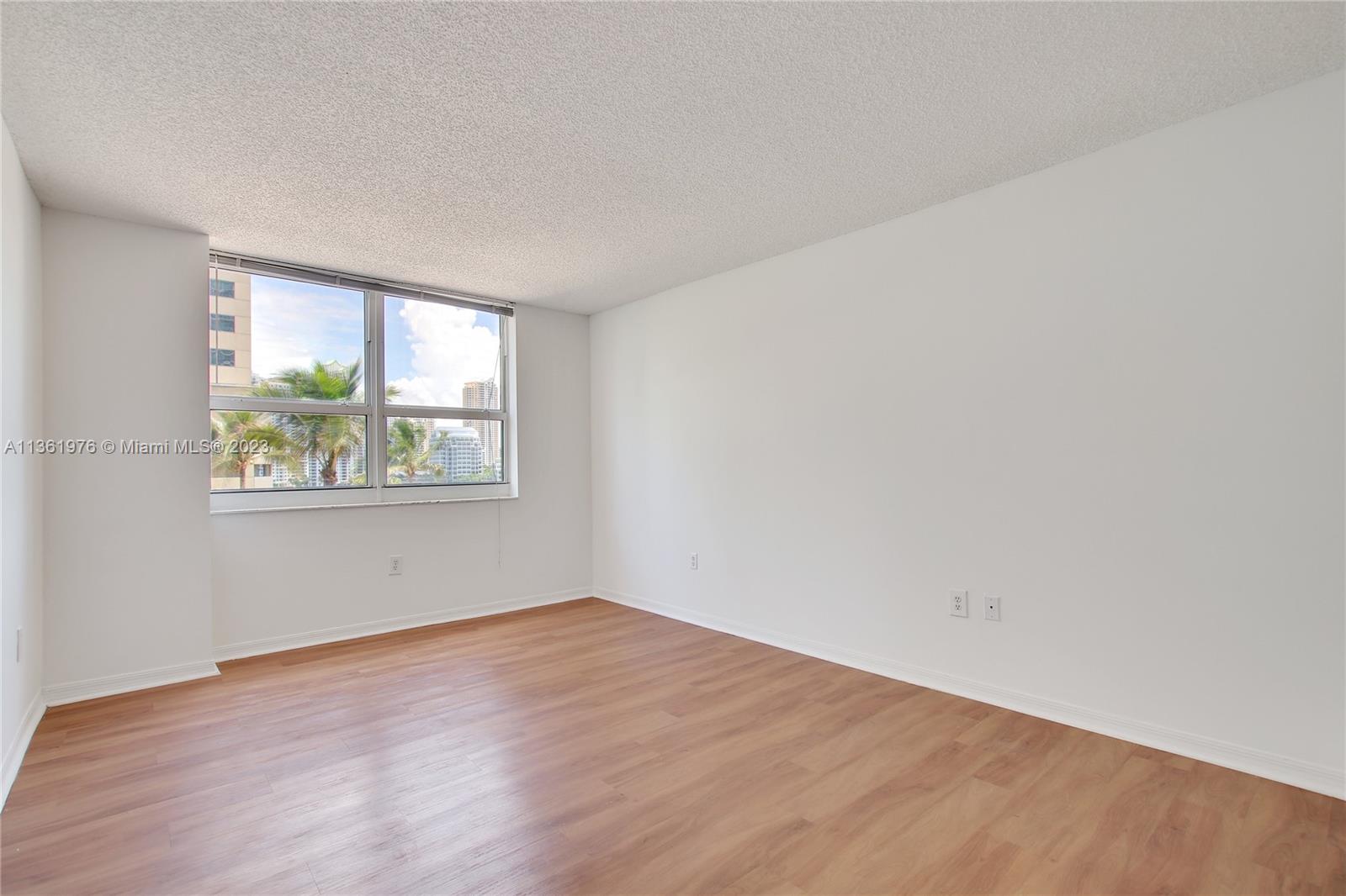 1111 Brickell Bay Drive, Unit 1102 Miami, FL 33131 - Photo 27 of 72 wooden floor in an empty room with a window