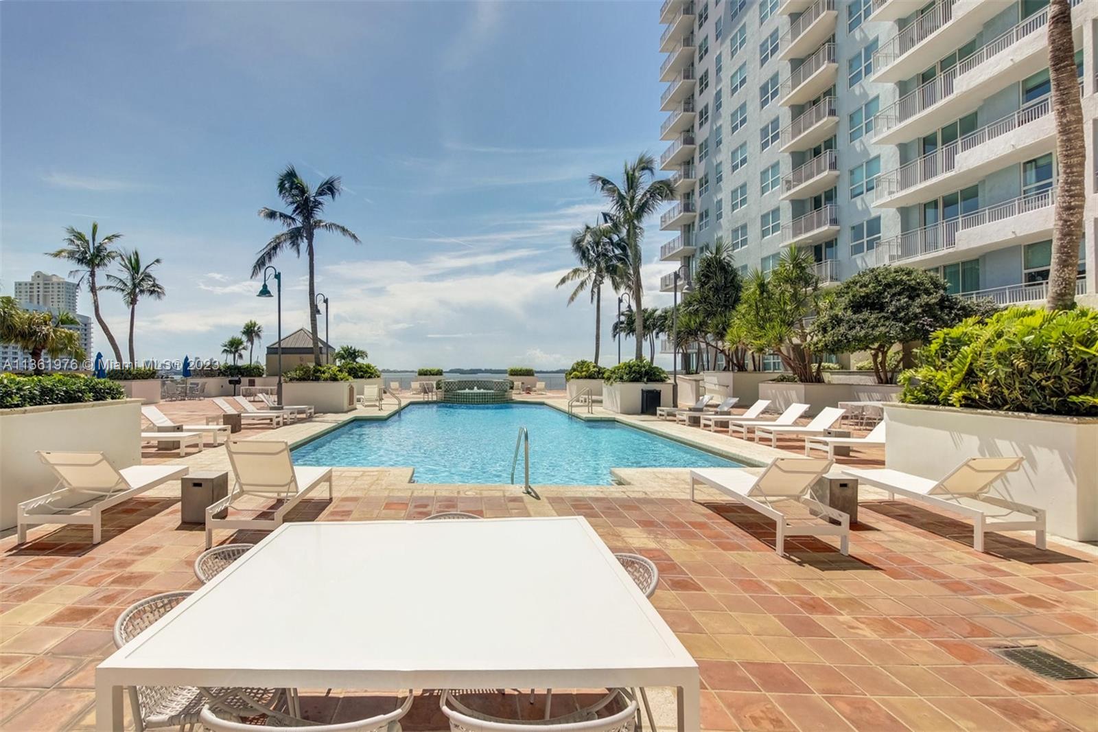 1111 Brickell Bay Drive, Unit 1102 Miami, FL 33131 - Photo 3 of 72 a view of a swimming pool with chairs