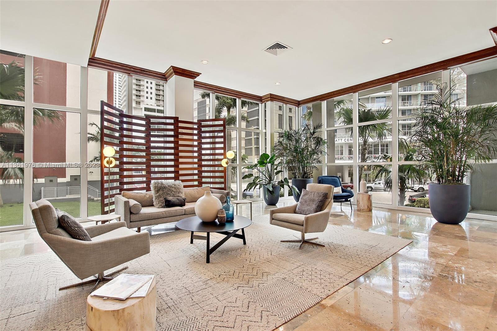 1111 Brickell Bay Drive, Unit 1102 Miami, FL 33131 - Photo 43 of 72 a living room with furniture and a potted plant