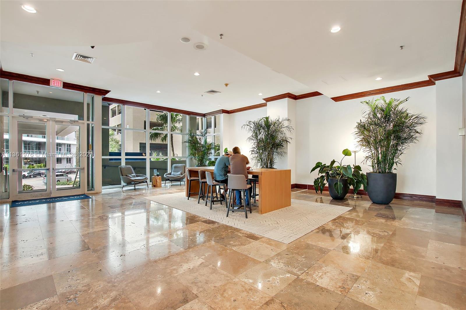1111 Brickell Bay Drive, Unit 1102 Miami, FL 33131 - Photo 45 of 72 a living room with furniture large window and potted plants