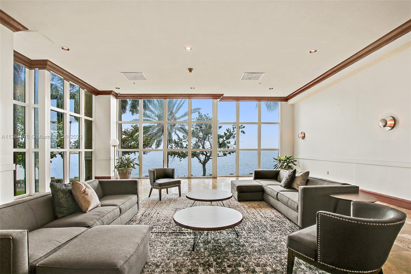 1111 Brickell Bay Drive, Unit 1102 Miami, FL 33131 - Photo 46 of 72 a living room with furniture and a potted plant