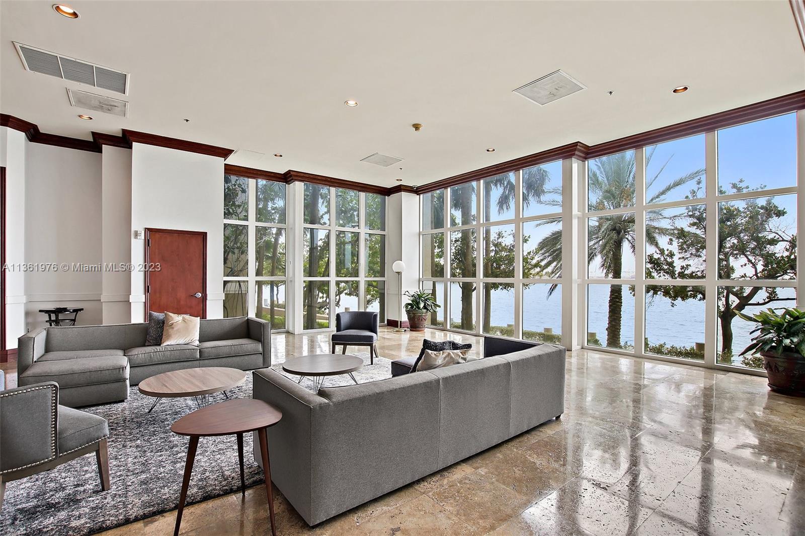 1111 Brickell Bay Drive, Unit 1102 Miami, FL 33131 - Photo 47 of 72 a living room with furniture and a large window