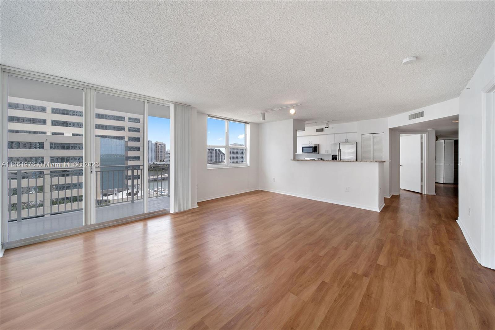 1111 Brickell Bay Drive, Unit 1102 Miami, FL 33131 - Photo 5 of 72 a view of wooden floor and windows in a room