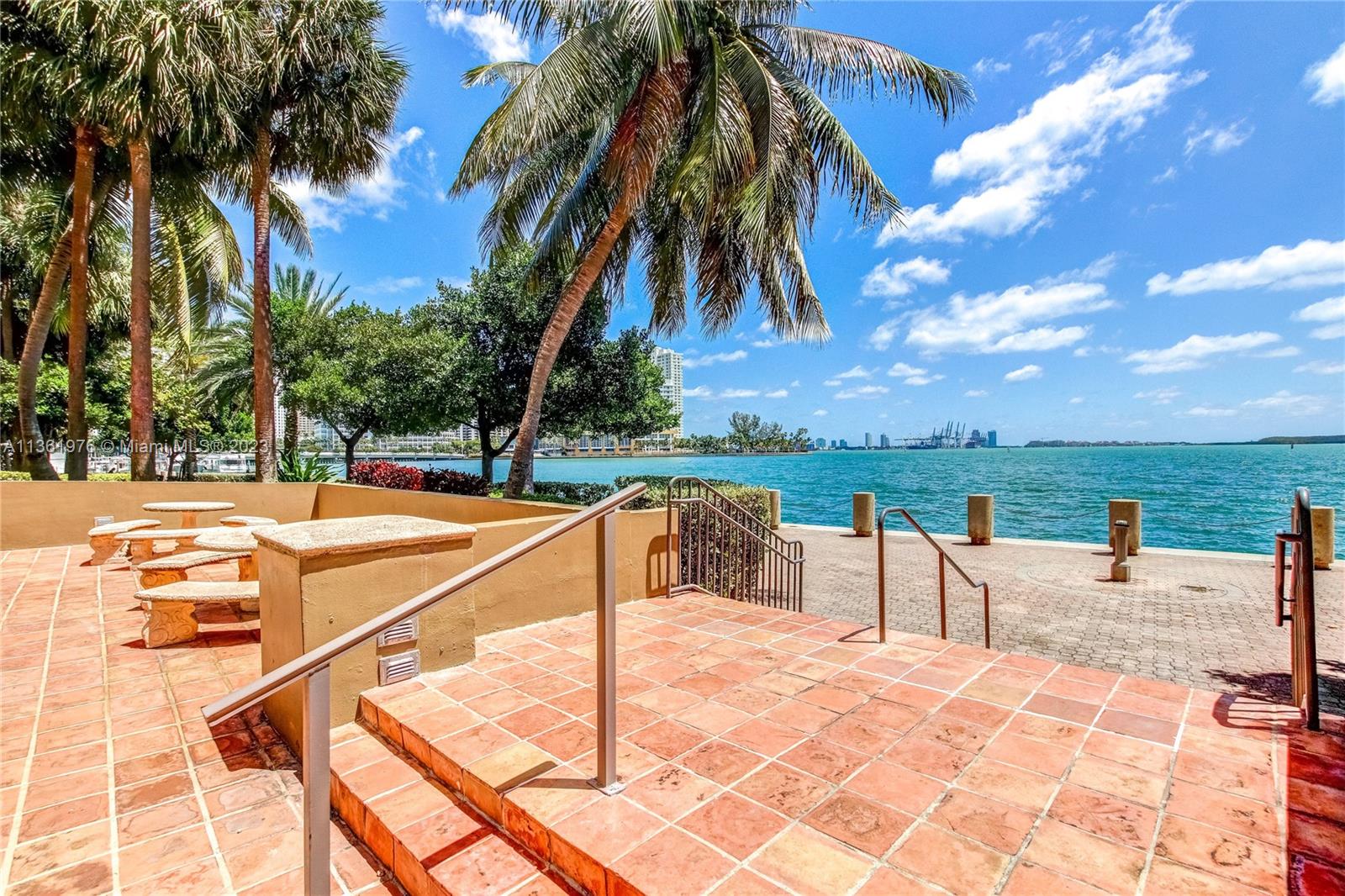 1111 Brickell Bay Drive, Unit 1102 Miami, FL 33131 - Photo 51 of 72 a view of a swimming pool with a lounge chairs