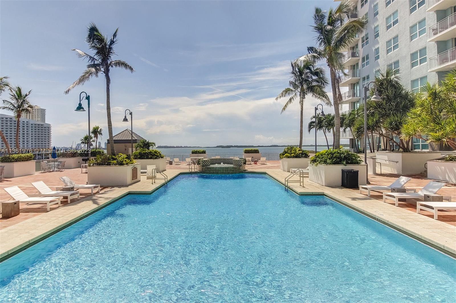 1111 Brickell Bay Drive, Unit 1102 Miami, FL 33131 - Photo 58 of 72 a view of a swimming pool with a yard