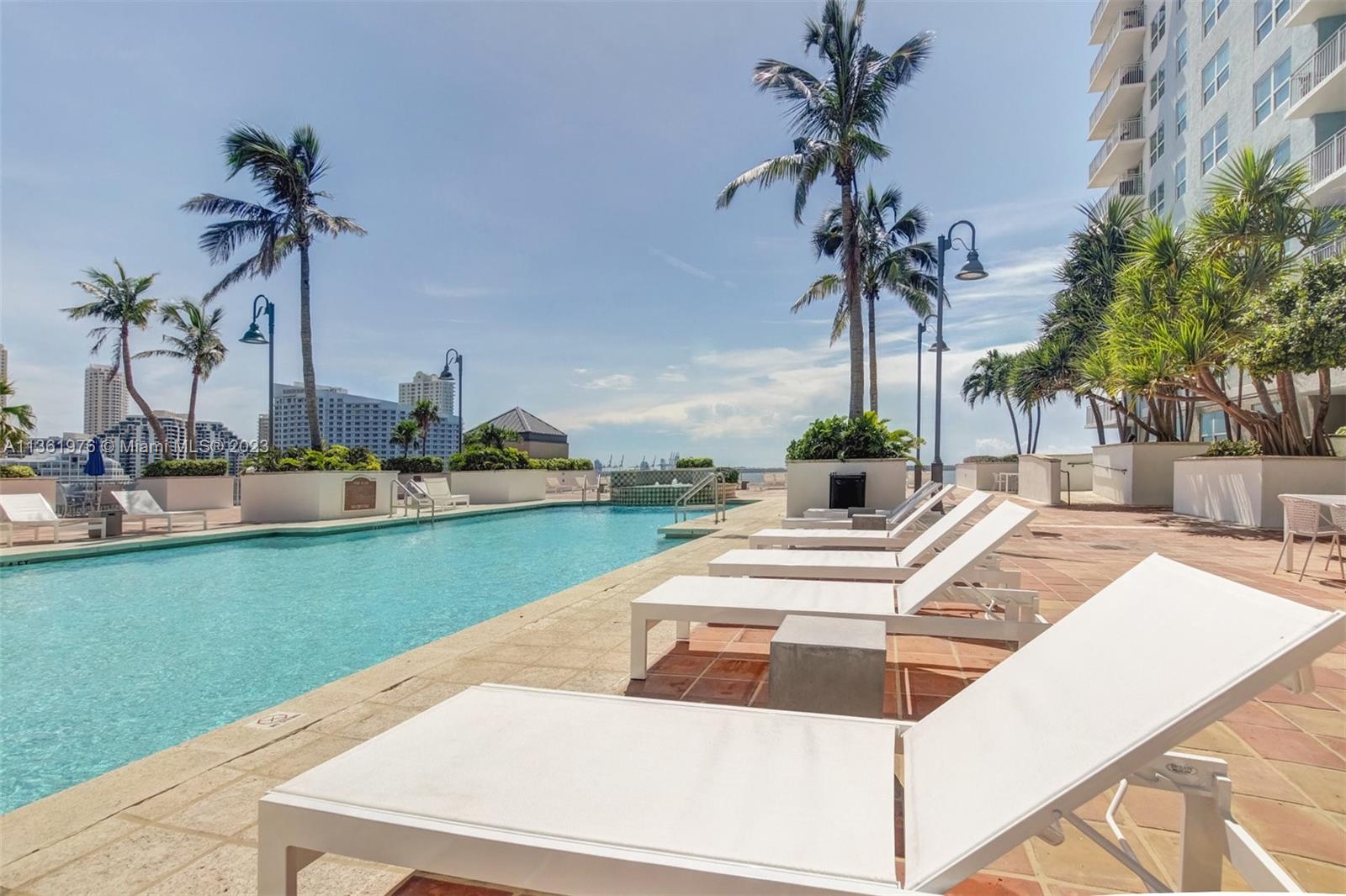 1111 Brickell Bay Drive, Unit 1102 Miami, FL 33131 - Photo 59 of 72 a view of a house with a swimming pool and a yard