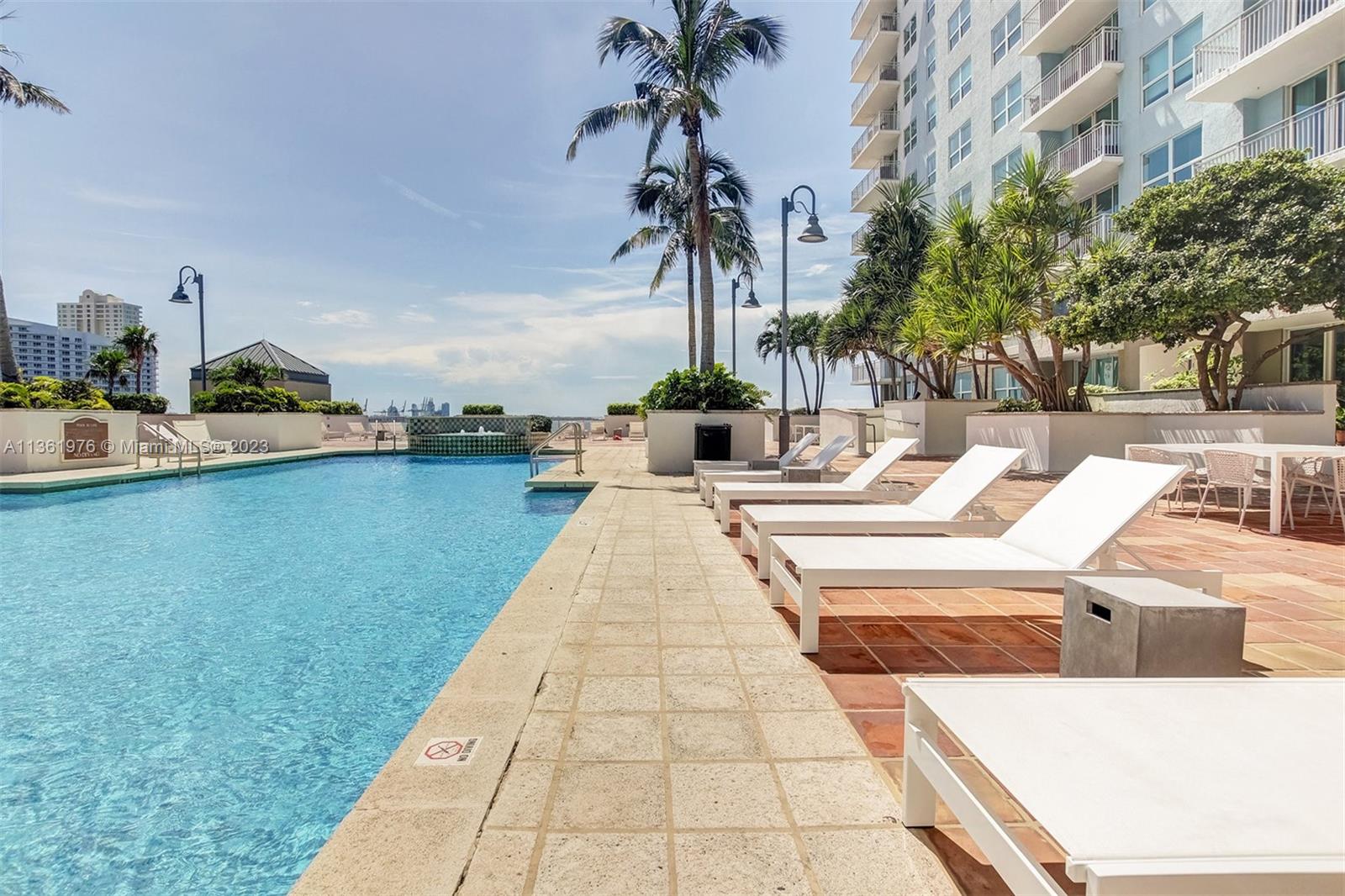 1111 Brickell Bay Drive, Unit 1102 Miami, FL 33131 - Photo 60 of 72 a view of swimming pool with outdoor seating and plants