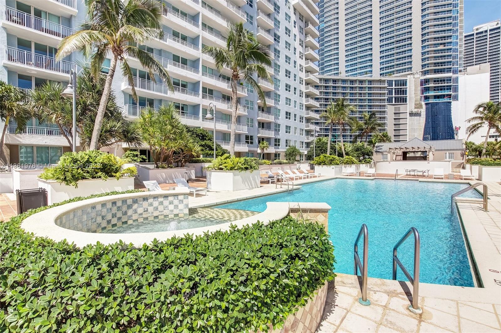 1111 Brickell Bay Drive, Unit 1102 Miami, FL 33131 - Photo 65 of 72 a view of a swimming pool with a patio