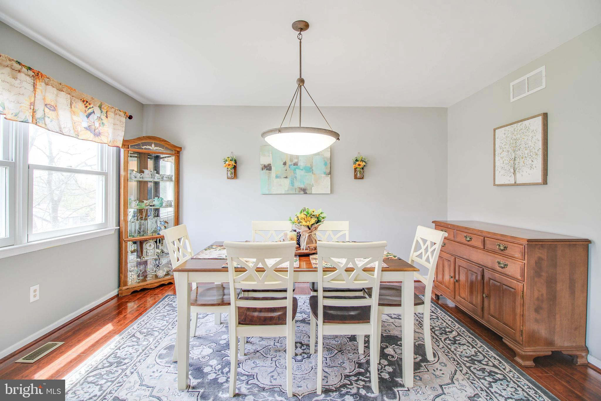 2408 Old Frederick Road Catonsville, MD 21228 - Photo 10 of 53 a dining room with furniture a chandelier and wooden floor