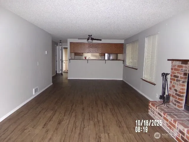 a view of a kitchen with wooden floor and a sink
