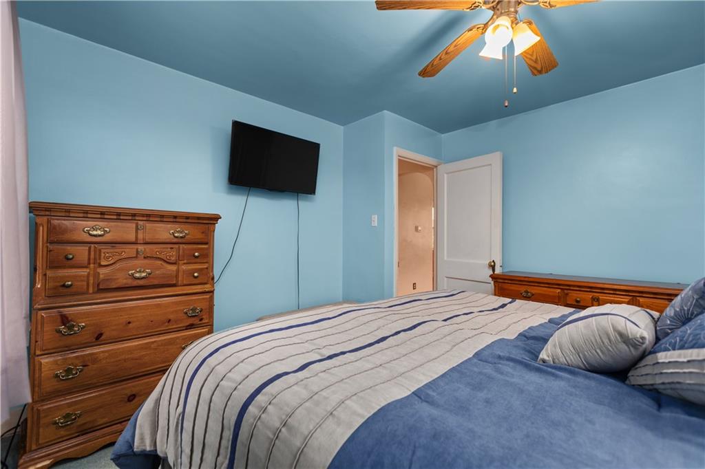 10204 Pearl Road Pittsburgh, PA 15235 - Photo 11 of 32 a bedroom with a bed and wooden floor