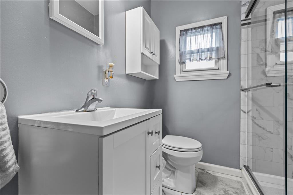 10204 Pearl Road Pittsburgh, PA 15235 - Photo 14 of 32 a bathroom with a sink a toilet and a window