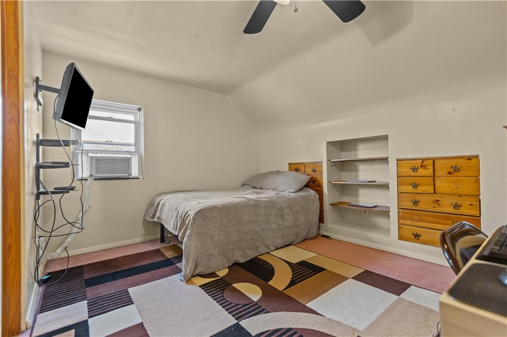 10204 Pearl Road Pittsburgh, PA 15235 - Photo 16 of 32 a bedroom with a bed and flat screen tv