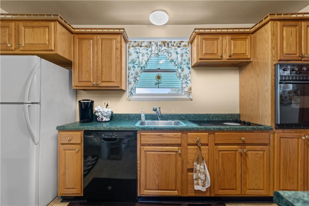 10204 Pearl Road Pittsburgh, PA 15235 - Photo 7 of 32 a kitchen with stainless steel appliances granite countertop a refrigerator and a stove