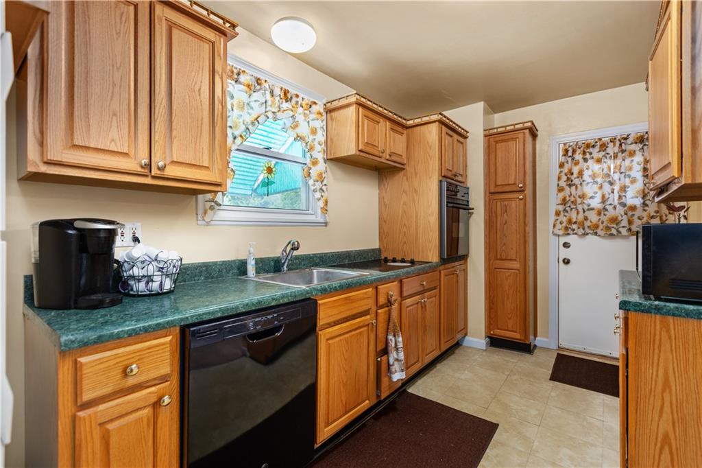 10204 Pearl Road Pittsburgh, PA 15235 - Photo 8 of 32 a kitchen with stainless steel appliances granite countertop a sink stove and refrigerator