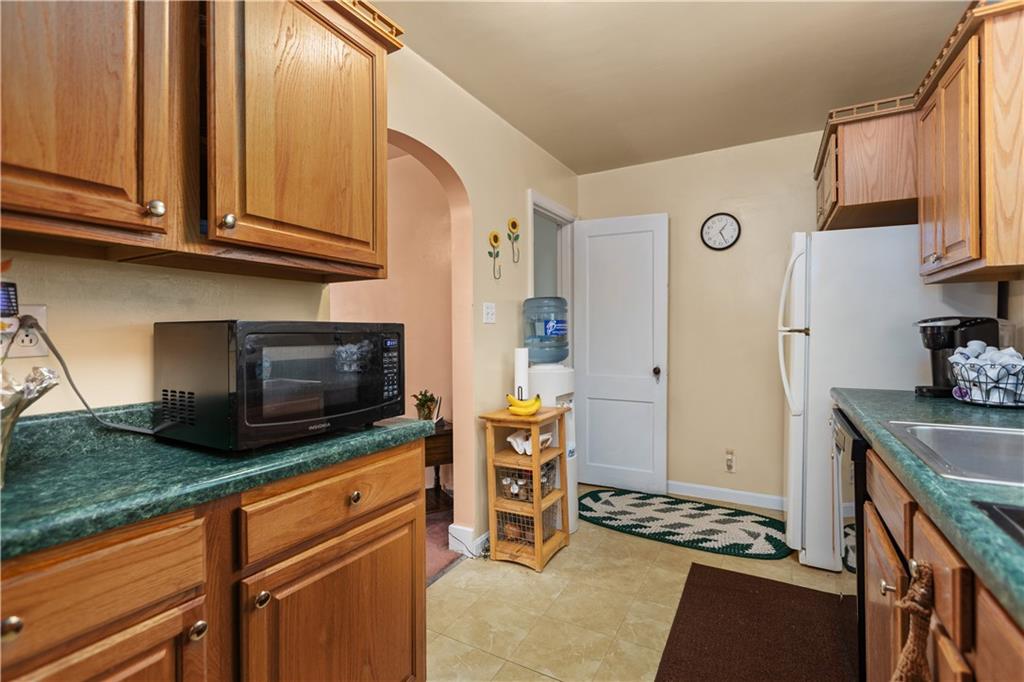 10204 Pearl Road Pittsburgh, PA 15235 - Photo 9 of 32 a kitchen with stainless steel appliances granite countertop a stove and a microwave