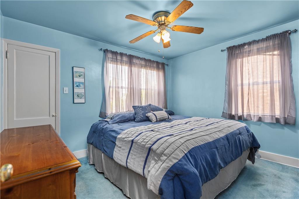 10204 Pearl Road Pittsburgh, PA 15235 - Photo 10 of 32 a bedroom with a bed and a chandelier