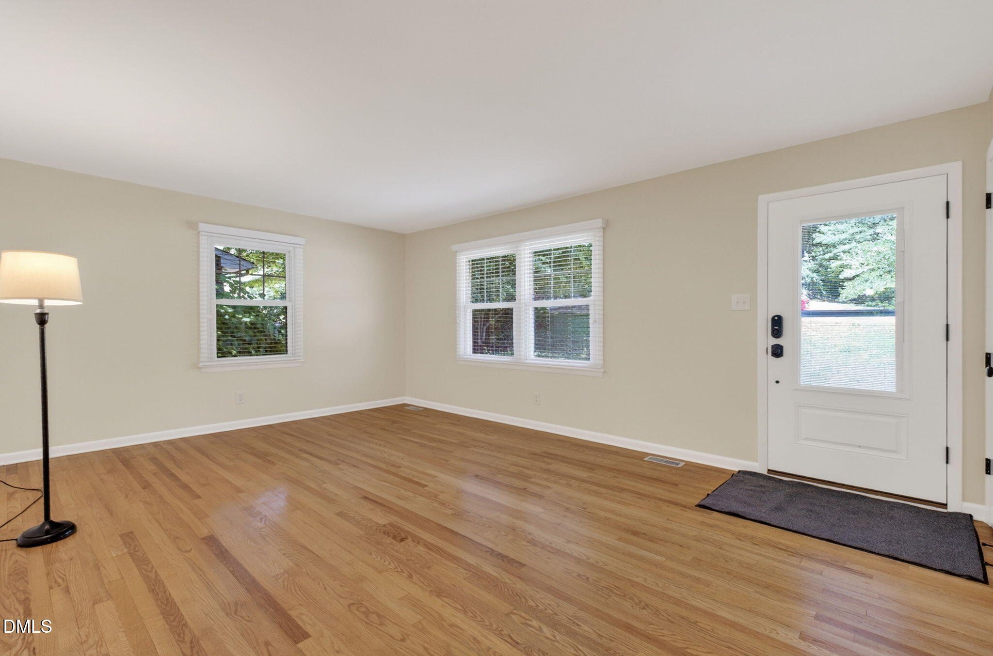 1224 Pineview Drive Raleigh, NC 27606 - Photo 8 of 45 a view of an empty room with window and wooden floor