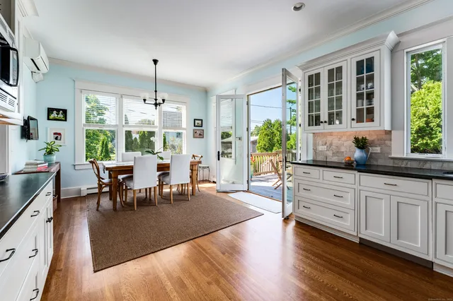 a living room with granite countertop kitchen island furniture and a chandelier