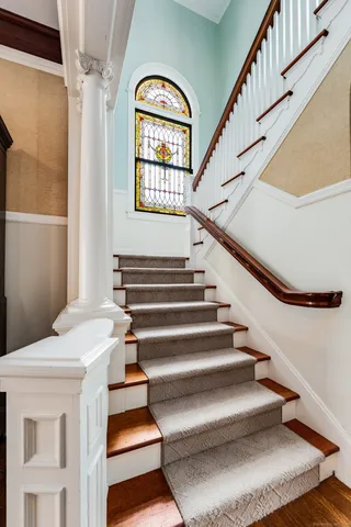 a view of entryway and hall with wooden floor