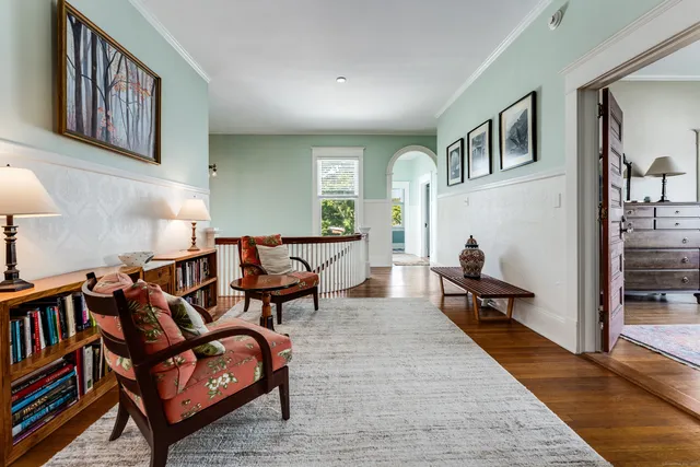 a living room with furniture rug and a window