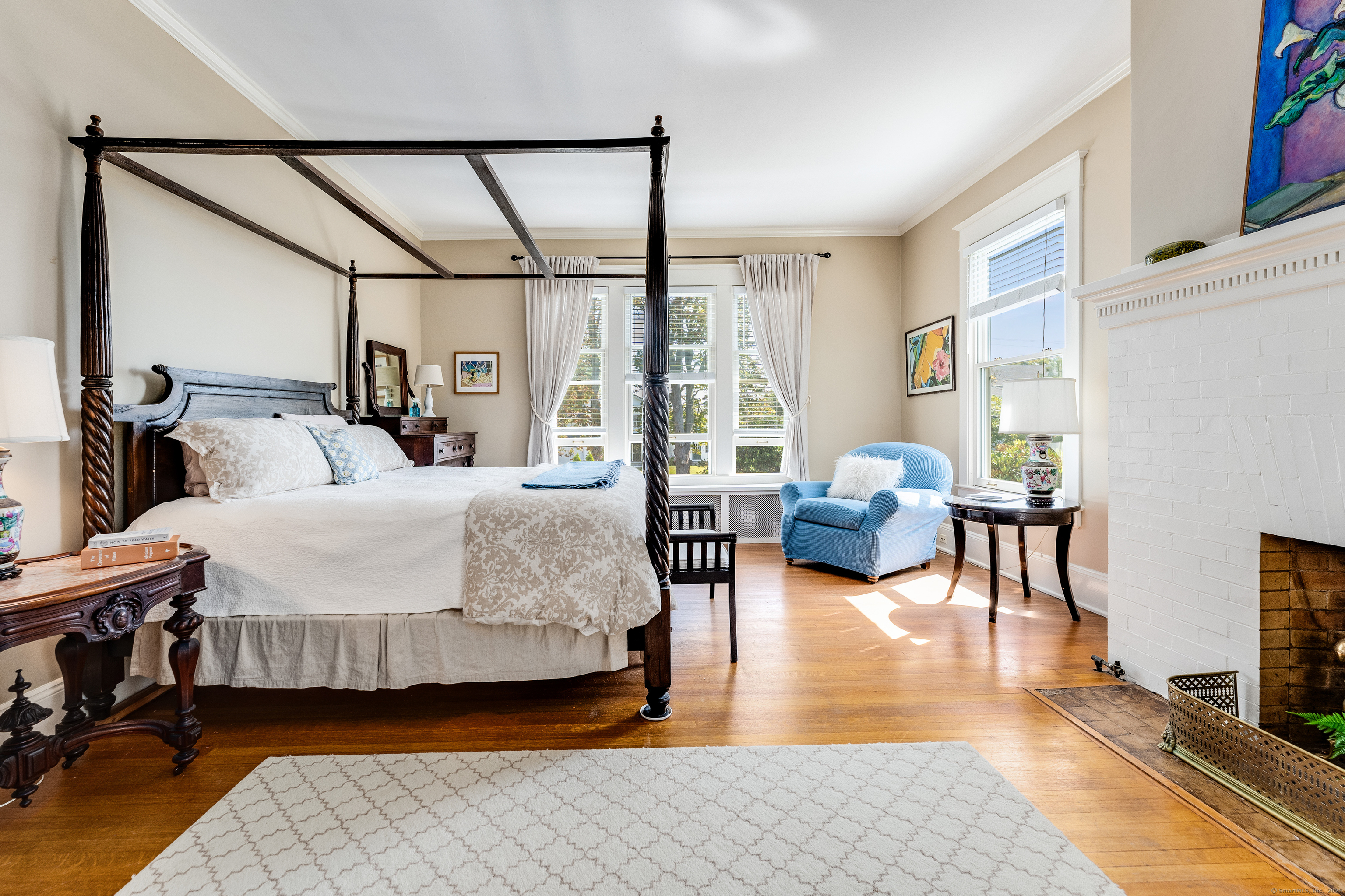 27 Church Street Groton, CT 06340 - Photo 24 of 37 a bedroom with double bed a couch and a large window