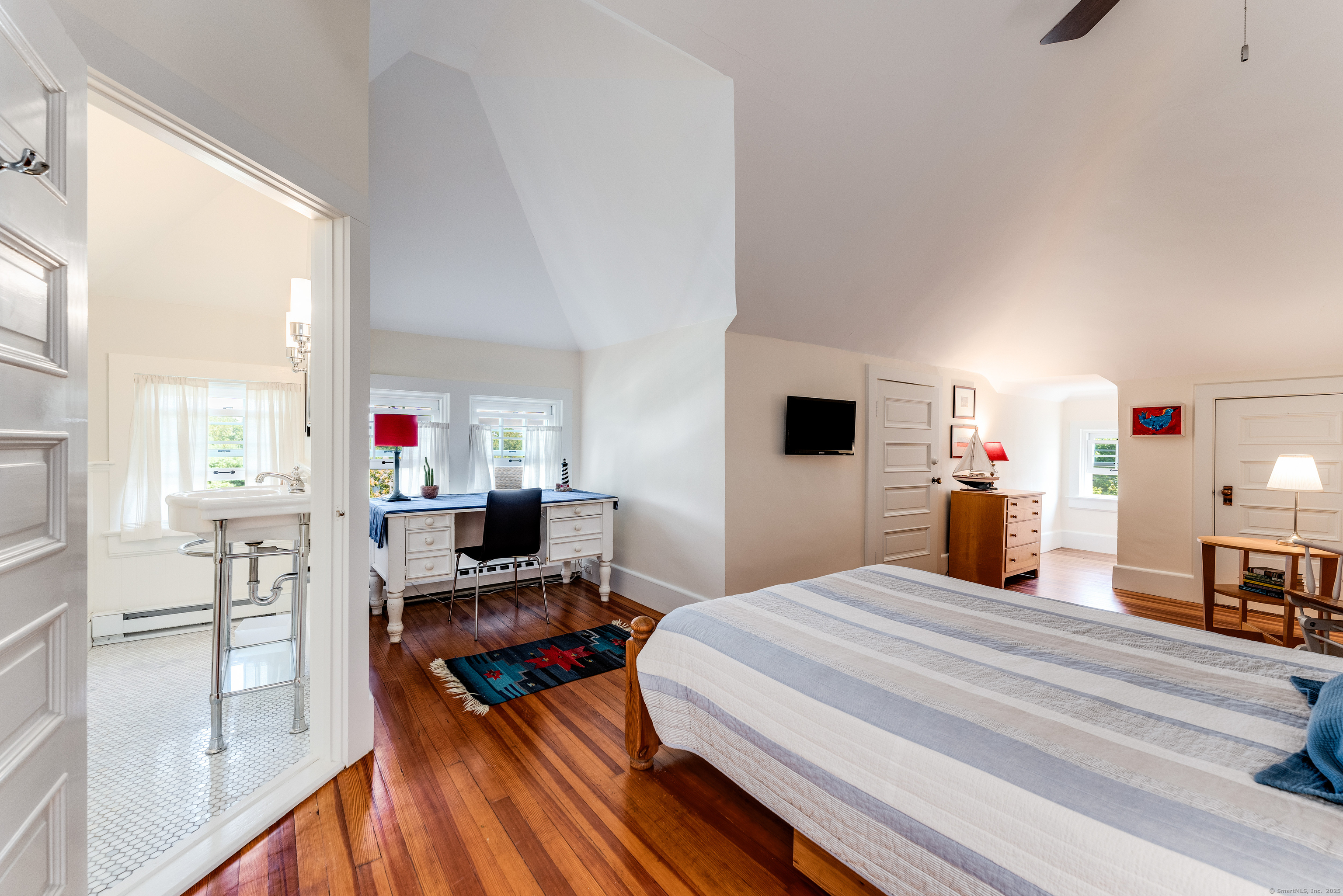 27 Church Street Groton, CT 06340 - Photo 29 of 37 a bedroom with a bed and wooden floor