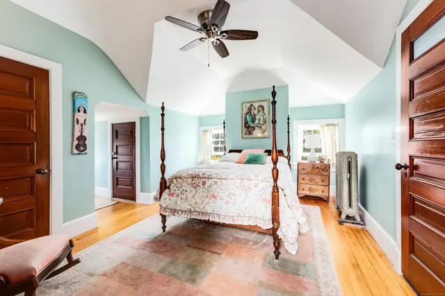 a bedroom with a bed couch and a window