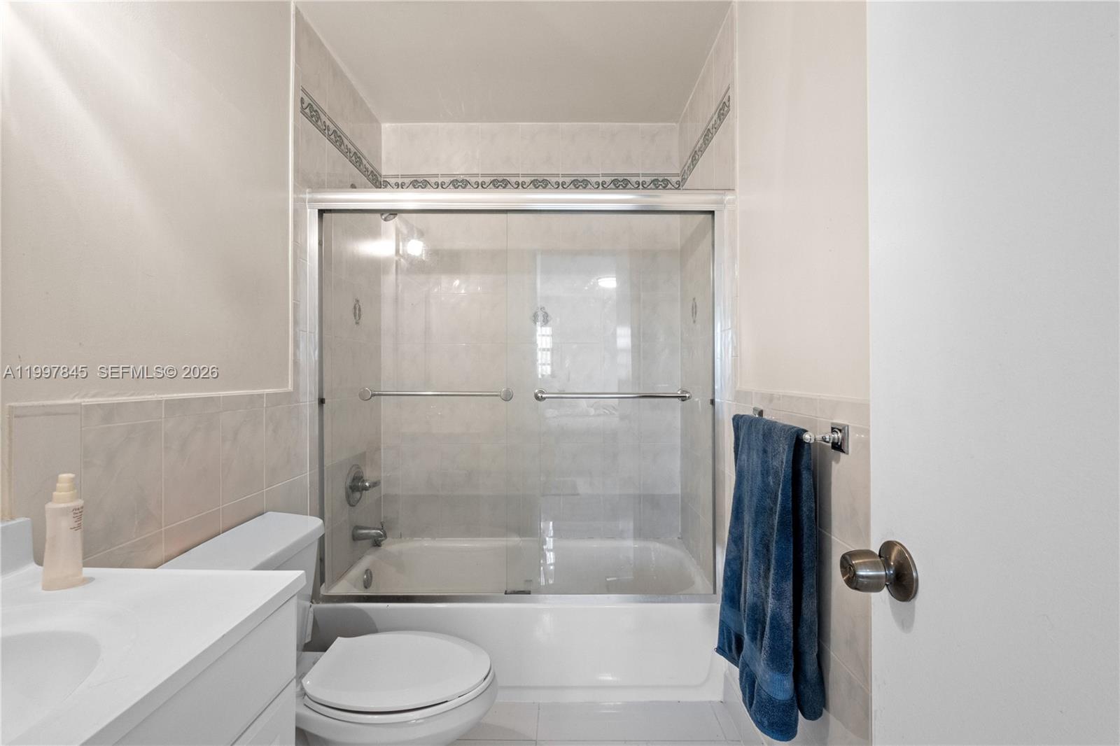 6211 Southwest 138th Court, Unit B Miami, FL 33183 - Photo 17 of 24 a bathroom with a bathtub shower sink vanity and toilet