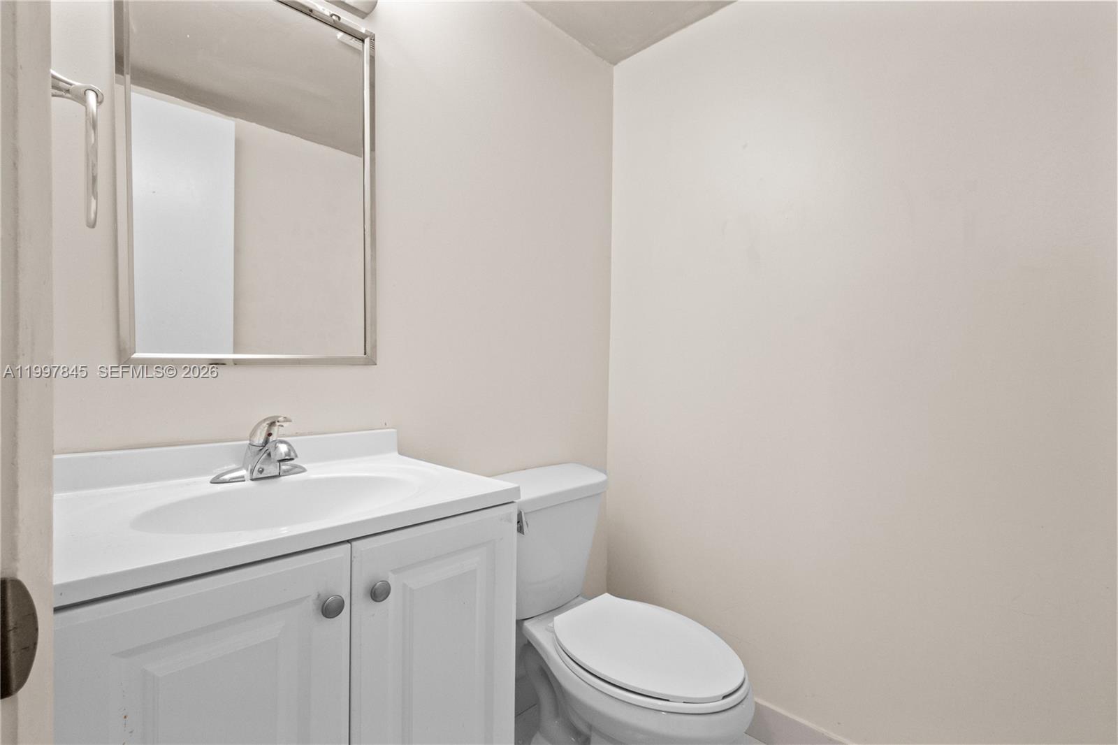 6211 Southwest 138th Court, Unit B Miami, FL 33183 - Photo 20 of 24 a bathroom with a sink a toilet and mirror