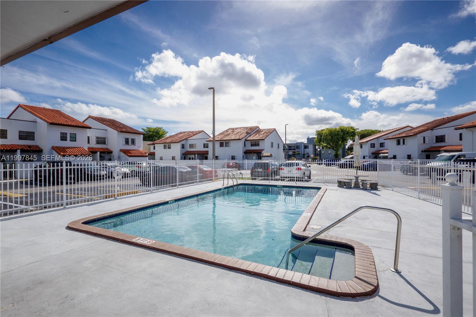 6211 Southwest 138th Court, Unit B Miami, FL 33183 - Photo 24 of 24 a view of a swimming pool and lounge chair