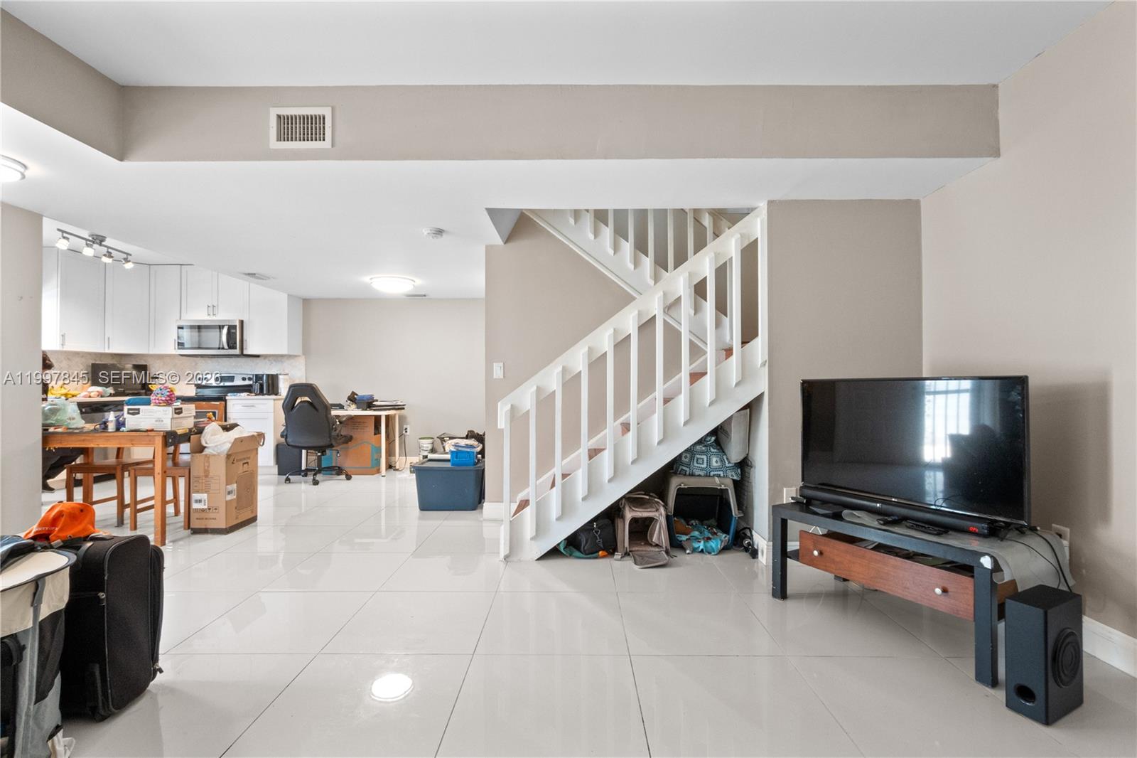 6211 Southwest 138th Court, Unit B Miami, FL 33183 - Photo 7 of 24 a living room with furniture and a flat screen tv