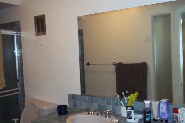 a bathroom with a sink mirror and vanity
