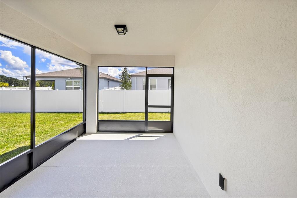 6784 Southwest 90th Loop Ocala, FL 34476 - Photo 9 of 11 a view of an empty room with a large window