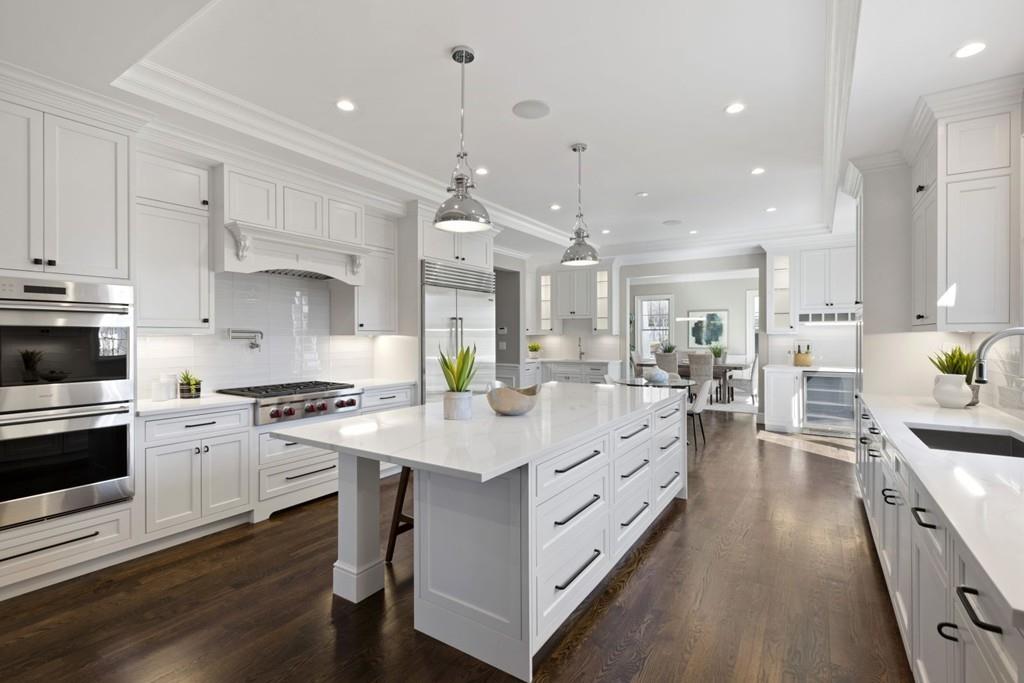 11 Fairhaven Road Newton, MA 02459 - Photo 11 of 40 a large kitchen with stainless steel appliances lots of counter space and wooden floor