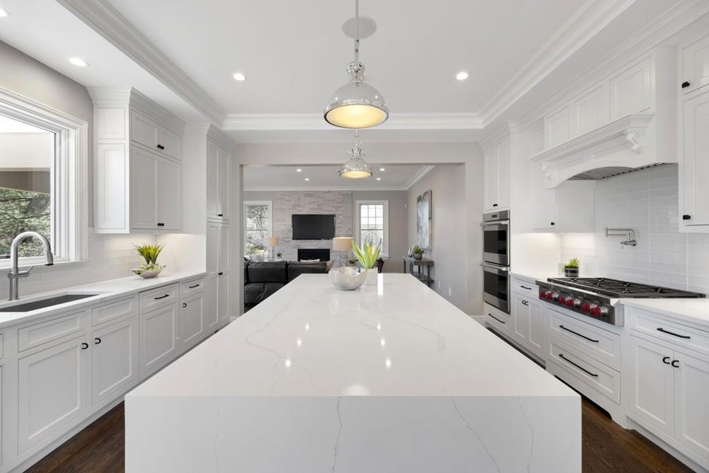 11 Fairhaven Road Newton, MA 02459 - Photo 15 of 40 a large white kitchen with lots of counter space and stainless steel appliances